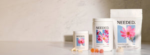 Needed Prenatal Multi capsules, Prenatal Multi Gummy and Prenatal Multi Powder on a marble counter