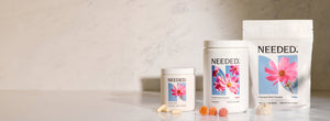 Needed Prenatal Multi capsules, Prenatal Multi Gummy and Prenatal Multi Powder on a marble counter