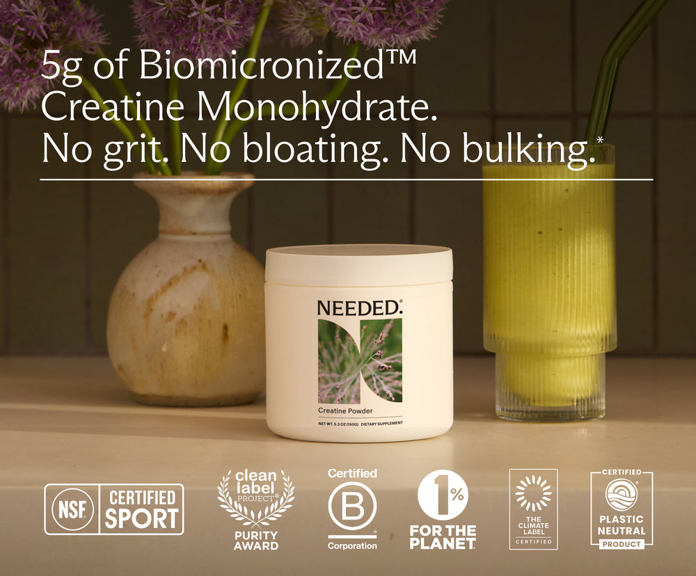 Women's Creatine jar beside a green smoothie. 5g of Biomicronized creatine monohydrate. No grit. No bloating. No bulking. NSF Certified for Sport, Clean Label Project Purity Award, Certified B Corporation, 1% for the Planet, The Climate Label certified and Plastic Neutral product.